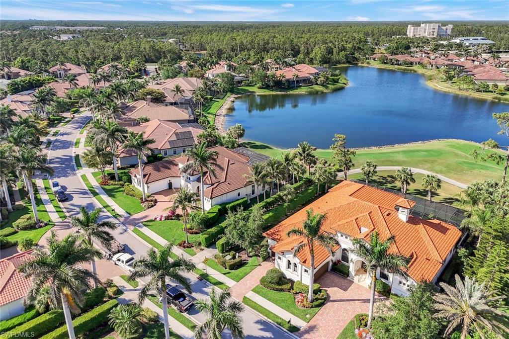 7304 Hagen Way Naples, FL 34113 - Photo 3 of 37 Drone / aerial view featuring a residential view, a water view, and a wooded view
