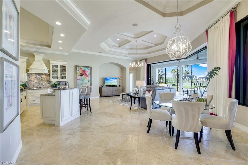 7304 Hagen Way Naples, FL 34113 - Photo 7 of 37 Dining area with baseboards, a chandelier, recessed lighting, and crown molding