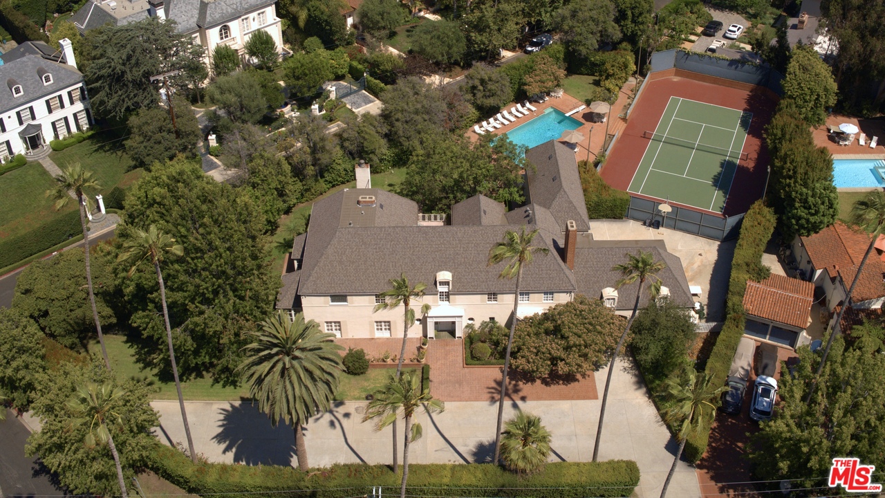 an aerial view of multiple houses with yard