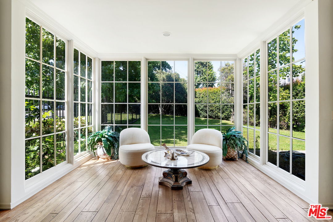 300 South Rockingham Avenue Los Angeles, CA 90049 - Photo 11 of 49 a balcony view with a large window and wooden floor