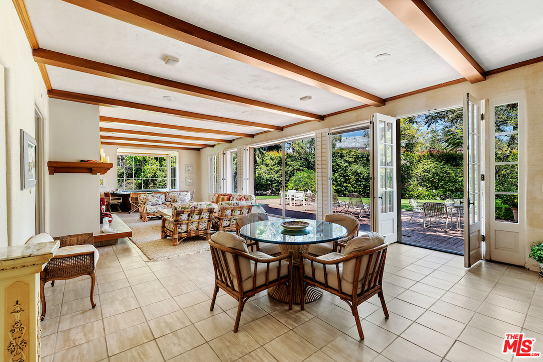 300 South Rockingham Avenue Los Angeles, CA 90049 - Photo 12 of 49 a living room with furniture and a floor to ceiling window