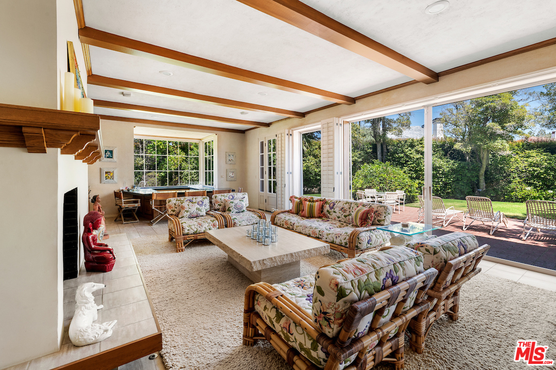 300 South Rockingham Avenue Los Angeles, CA 90049 - Photo 13 of 49 a living room with furniture and a fireplace