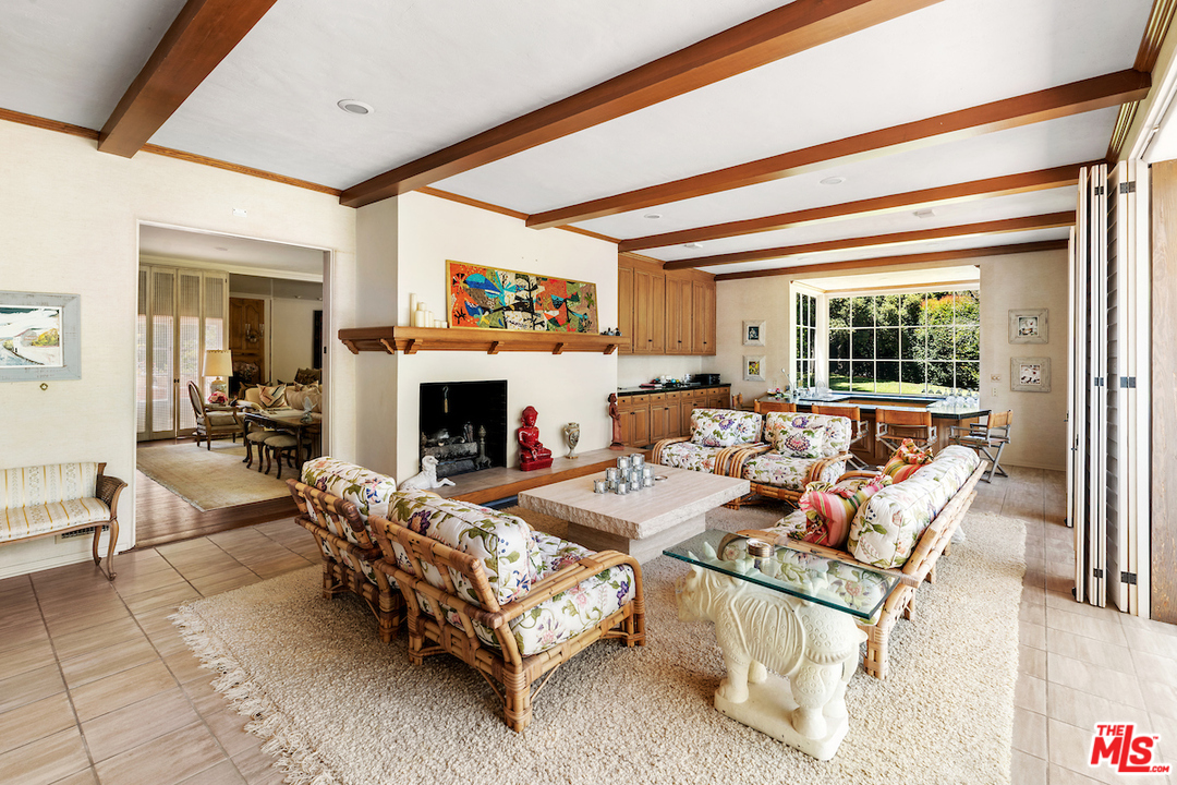 300 South Rockingham Avenue Los Angeles, CA 90049 - Photo 14 of 49 a living room with furniture and a fireplace