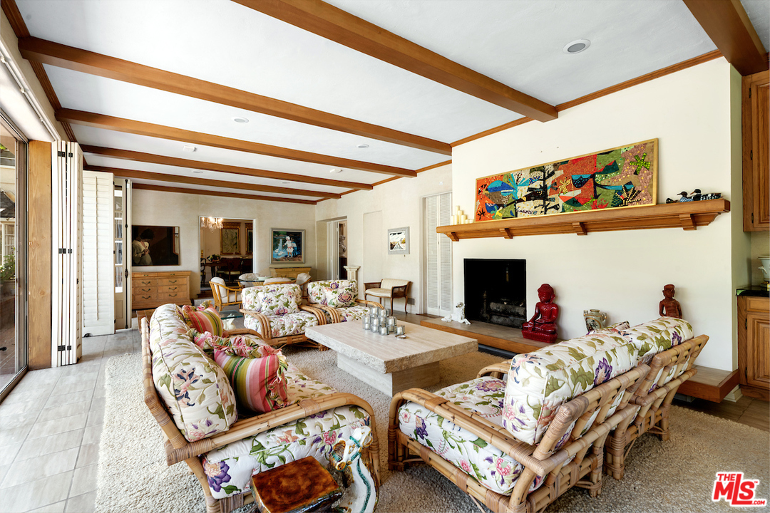 300 South Rockingham Avenue Los Angeles, CA 90049 - Photo 15 of 49 a living room with furniture a fireplace and a flat screen tv