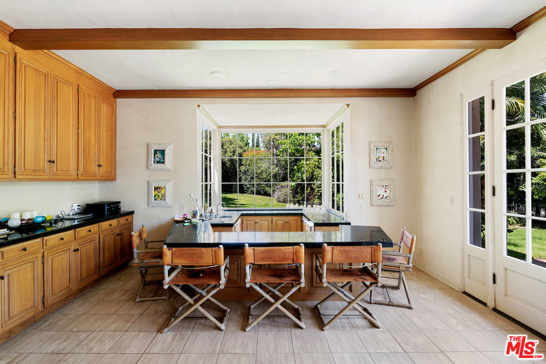 300 South Rockingham Avenue Los Angeles, CA 90049 - Photo 16 of 49 a kitchen with furniture a window and a sink
