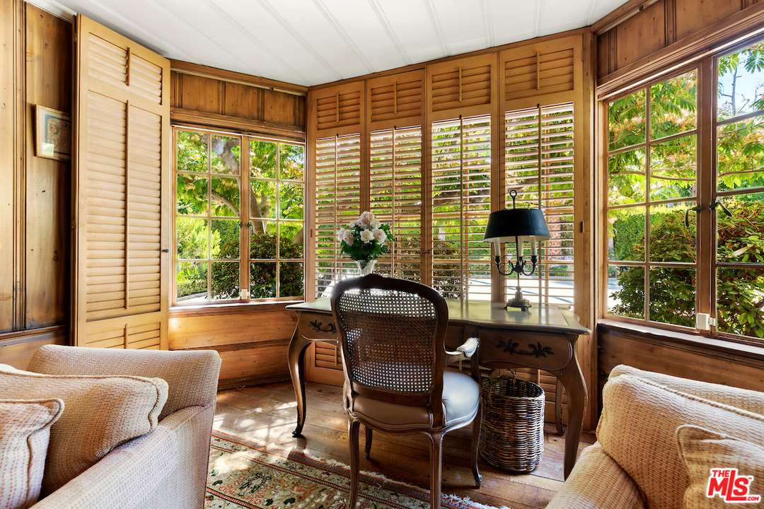 300 South Rockingham Avenue Los Angeles, CA 90049 - Photo 25 of 49 a living room with furniture and floor to ceiling windows