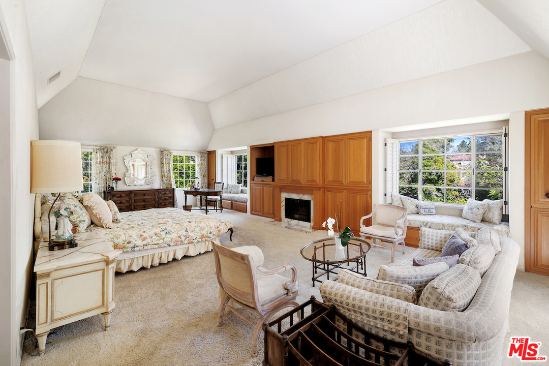 300 South Rockingham Avenue Los Angeles, CA 90049 - Photo 33 of 49 a living room with furniture large window and a fireplace
