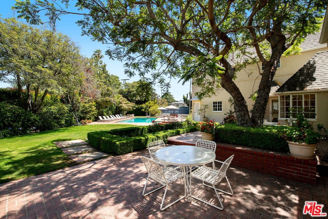 300 South Rockingham Avenue Los Angeles, CA 90049 - Photo 40 of 49 a view of a swimming pool with a patio