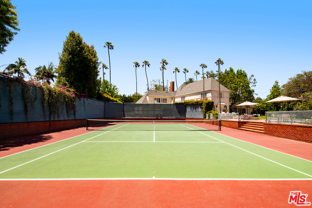 300 South Rockingham Avenue Los Angeles, CA 90049 - Photo 46 of 49 a front view of house with yard and swimming pool