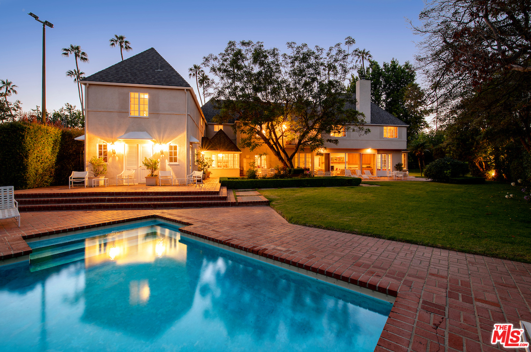 300 South Rockingham Avenue Los Angeles, CA 90049 - Photo 48 of 49 a view of swimming pool and trees in the background
