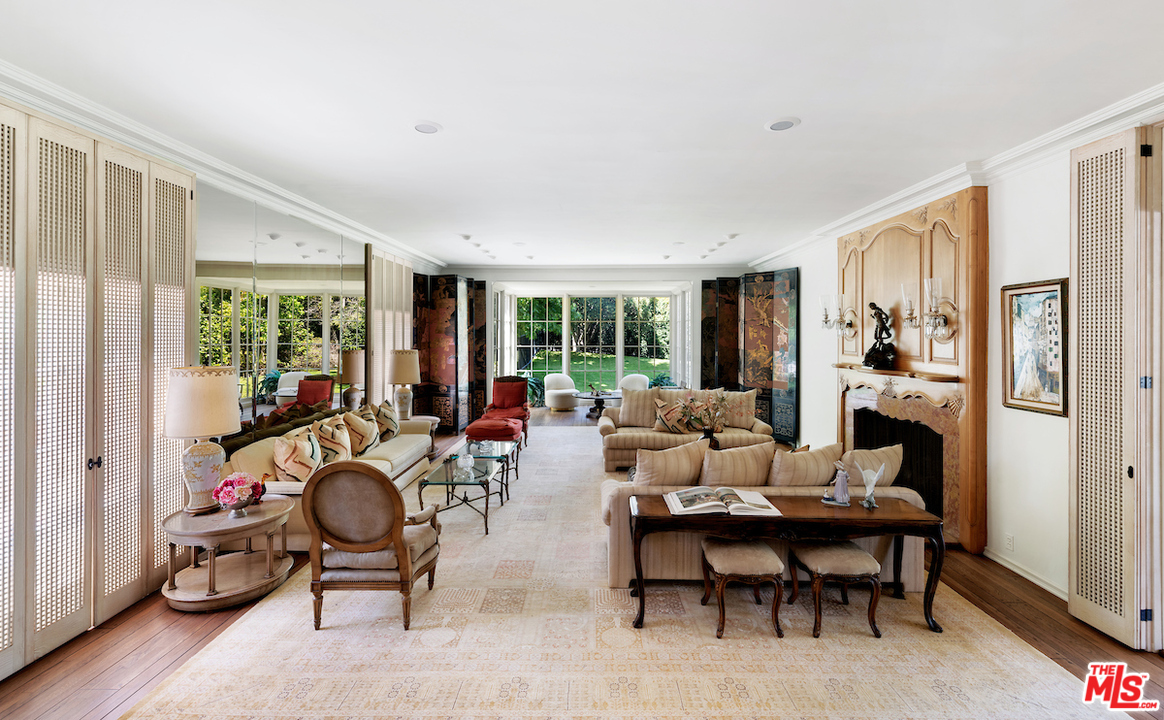 300 South Rockingham Avenue Los Angeles, CA 90049 - Photo 7 of 49 a living room with furniture and a large window