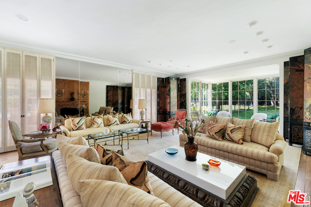 300 South Rockingham Avenue Los Angeles, CA 90049 - Photo 8 of 49 a living room with furniture and a fireplace