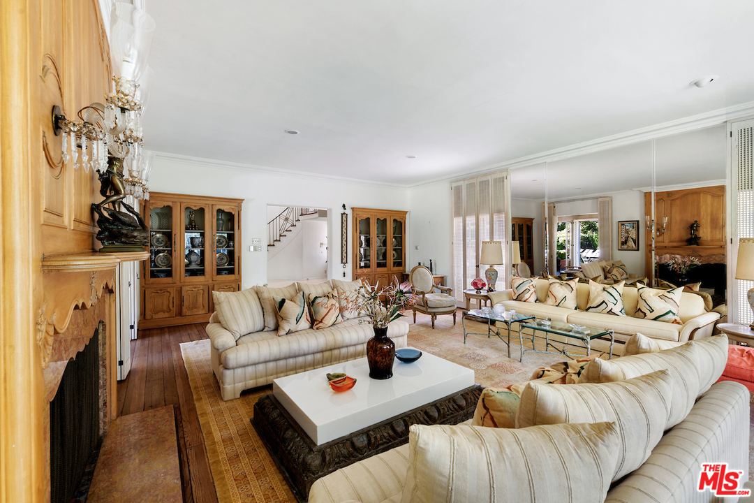 300 South Rockingham Avenue Los Angeles, CA 90049 - Photo 9 of 49 a living room with furniture and a fireplace