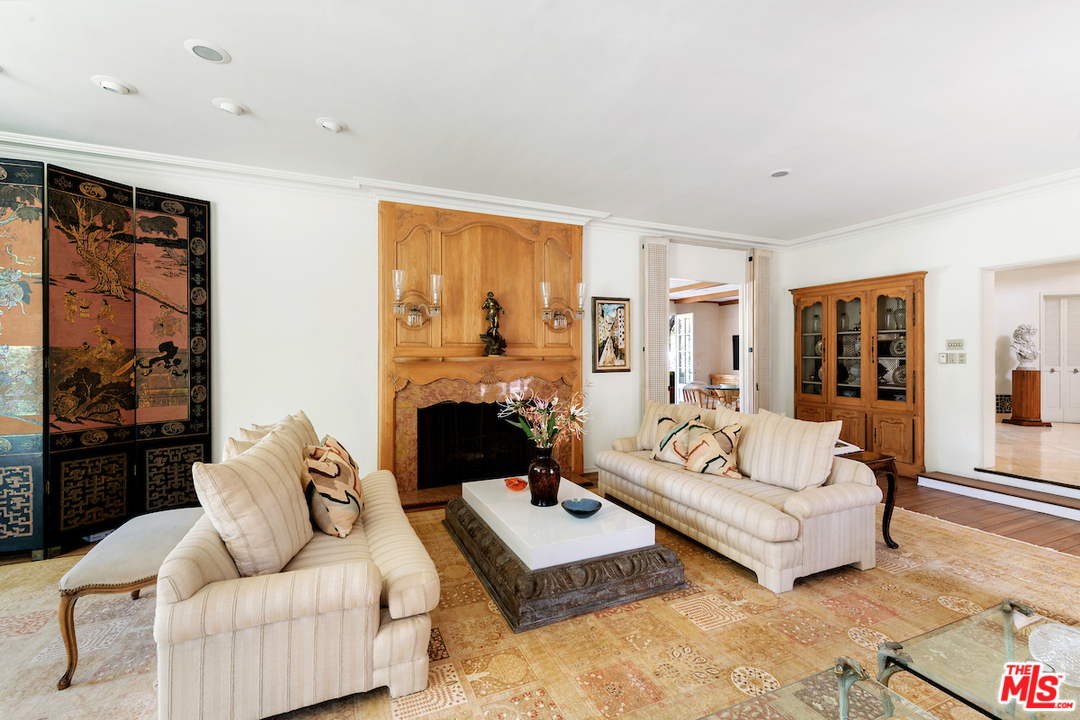 300 South Rockingham Avenue Los Angeles, CA 90049 - Photo 10 of 49 a living room with furniture and a fireplace