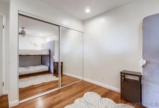 a bedroom with a bed and lamp on desk
