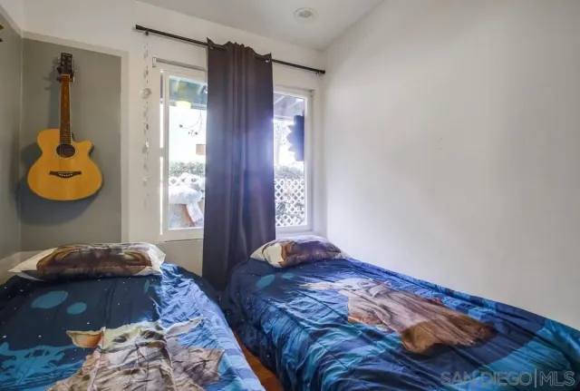 a bedroom with bed and a window