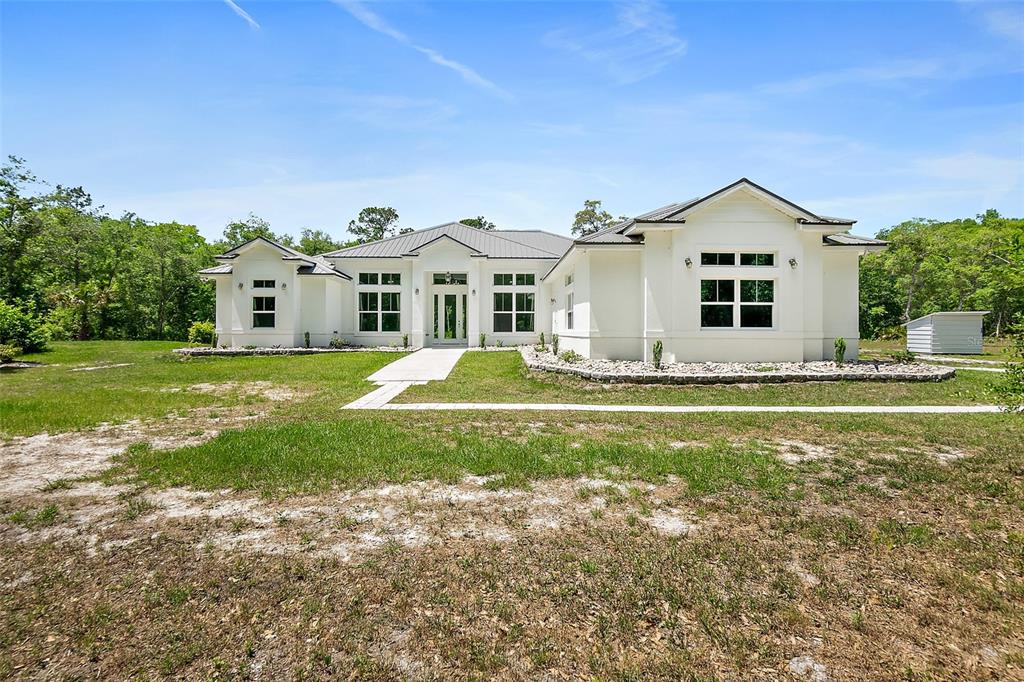 1370 Buckles Road Pierson, FL 32180 - Photo 1 of 57 a front view of a house with garden