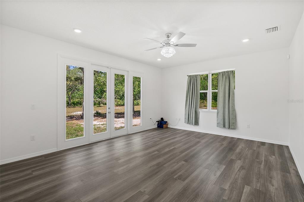 1370 Buckles Road Pierson, FL 32180 - Photo 15 of 57 a view of an empty room with a window and wooden floor