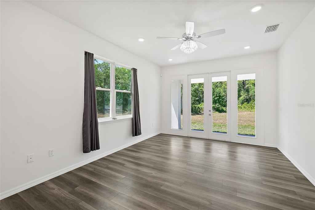 1370 Buckles Road Pierson, FL 32180 - Photo 17 of 57 a view of an empty room with wooden floor and a window