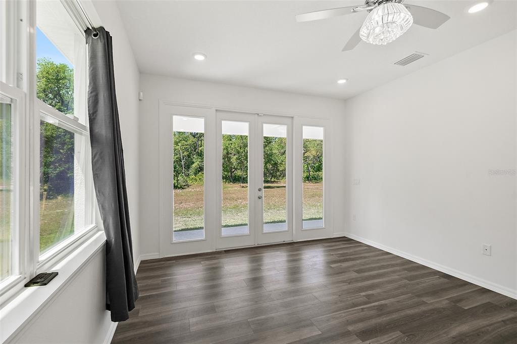 1370 Buckles Road Pierson, FL 32180 - Photo 18 of 57 a view of an empty room with wooden floor and a window