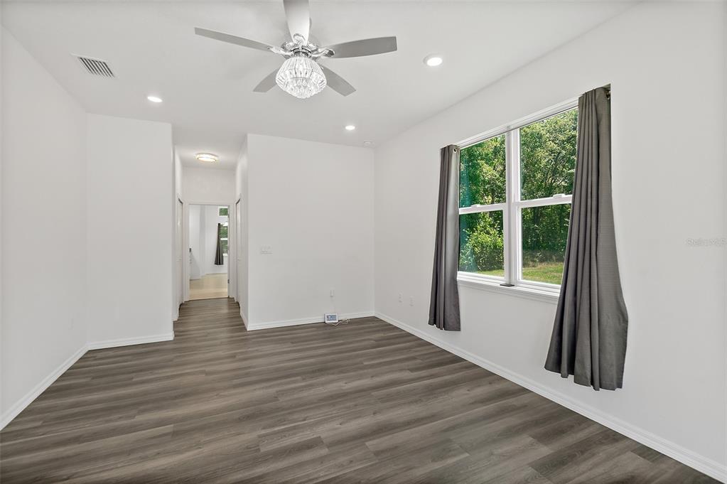1370 Buckles Road Pierson, FL 32180 - Photo 19 of 57 an empty room with wooden floor and windows