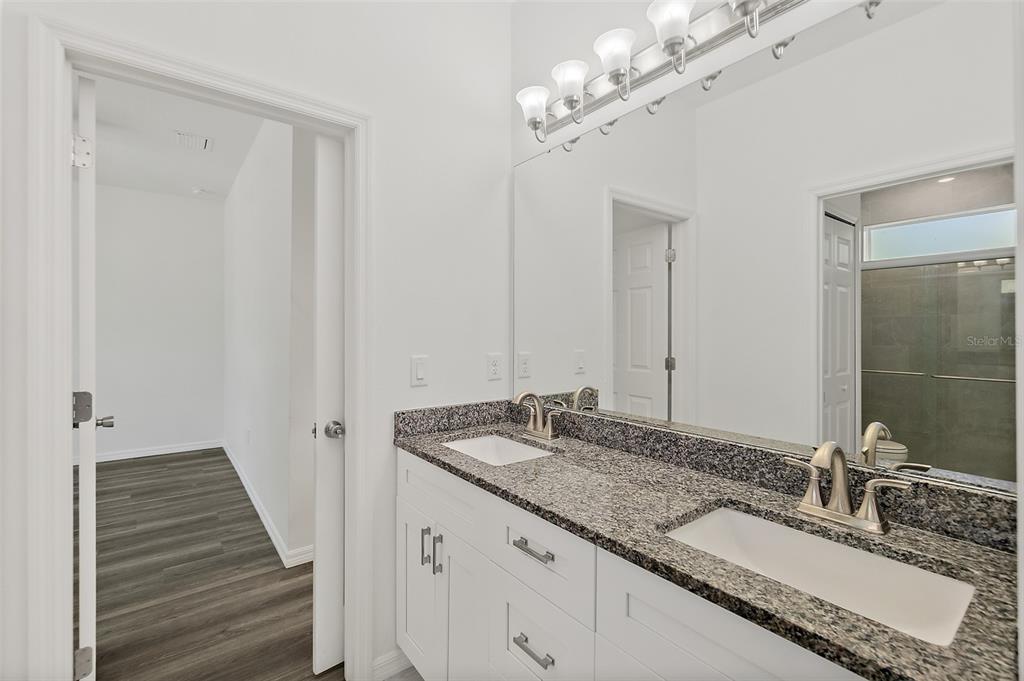 1370 Buckles Road Pierson, FL 32180 - Photo 24 of 57 a bathroom with a granite countertop double vanity sink and a mirror