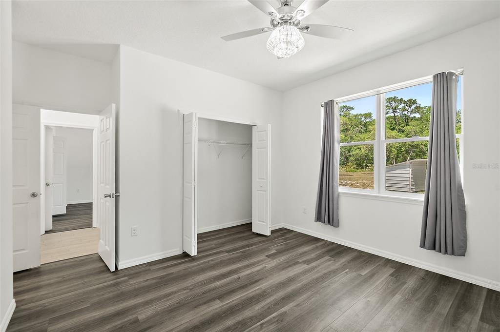 1370 Buckles Road Pierson, FL 32180 - Photo 26 of 57 a view of an empty room with wooden floor and a window