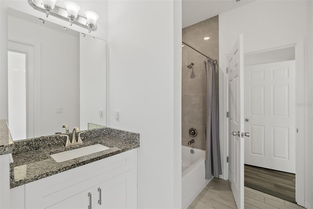 1370 Buckles Road Pierson, FL 32180 - Photo 32 of 57 a bathroom with a granite countertop sink two mirror and shower