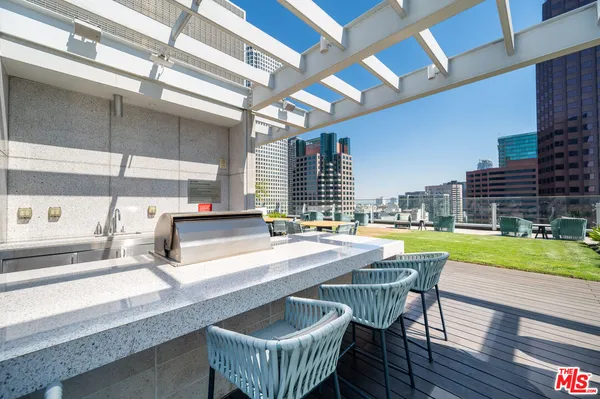 a kitchen with a table chairs and a barbeque grill