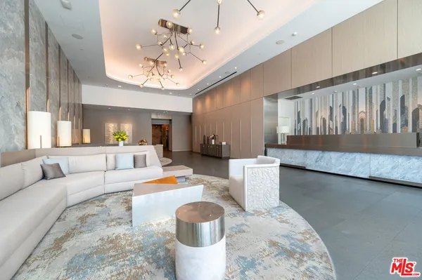 a living room with furniture and a chandelier