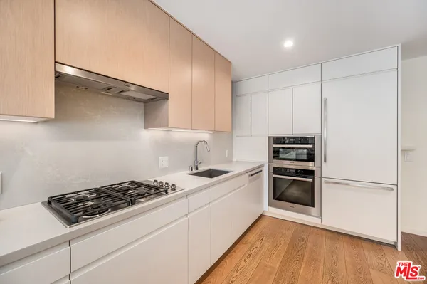 a kitchen with a stove and a refrigerator