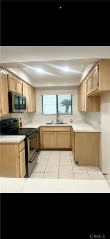 a view of kitchen with sink and cabinets