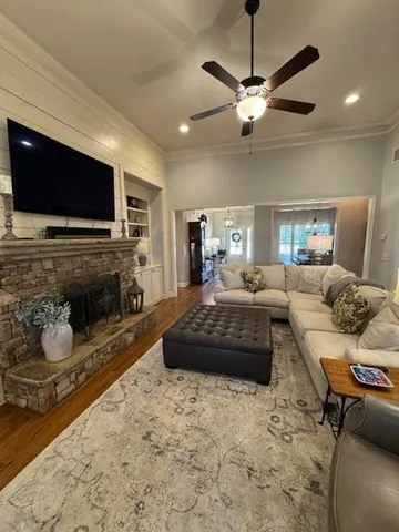 a living room with furniture flat screen tv and a fireplace
