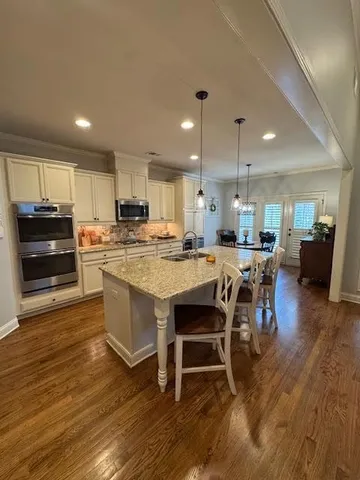 a view of a dining room with furniture wooden floor and chandelier