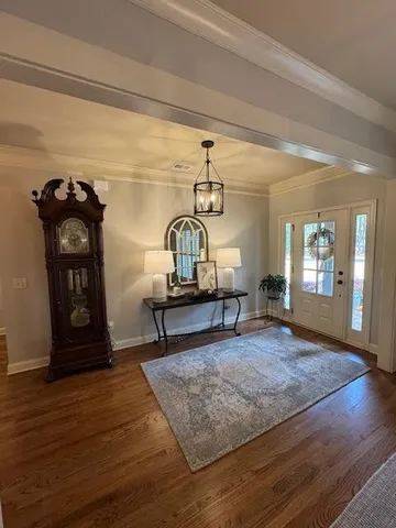 a view of a livingroom with furniture window and wooden floor