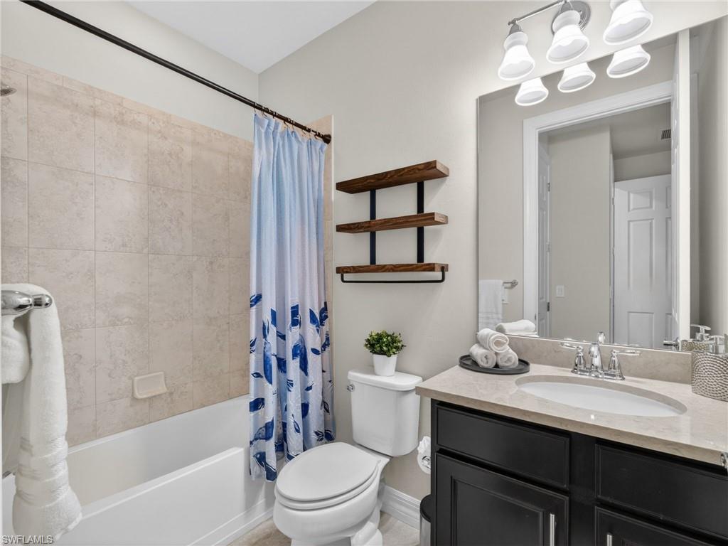 6124 Victory Drive Ave Maria, FL 34142 - Photo 35 of 50 a bathroom with a sink a toilet and bathtub