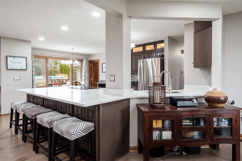 2412 Squaw Prairie Road Belvidere, IL 61008 - Photo 12 of 40 a kitchen with granite countertop a table and chairs in it