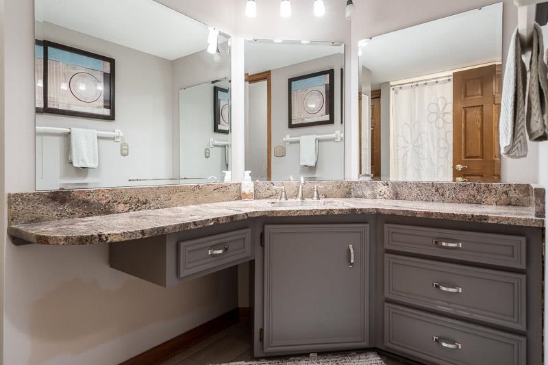 2412 Squaw Prairie Road Belvidere, IL 61008 - Photo 20 of 40 a bathroom with a granite countertop sink and a mirror