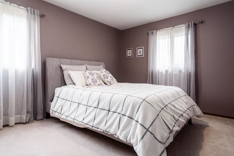 2412 Squaw Prairie Road Belvidere, IL 61008 - Photo 24 of 40 a bed sitting in a bedroom next to a window