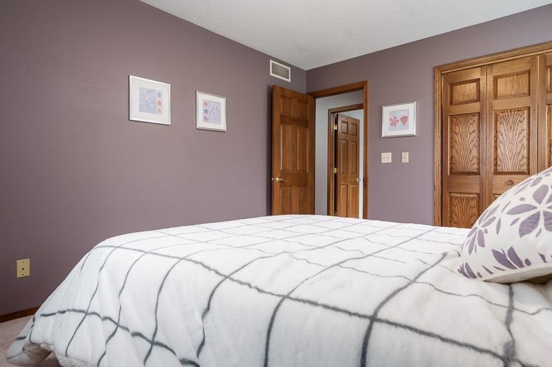 2412 Squaw Prairie Road Belvidere, IL 61008 - Photo 25 of 40 a bedroom with a bed and a window