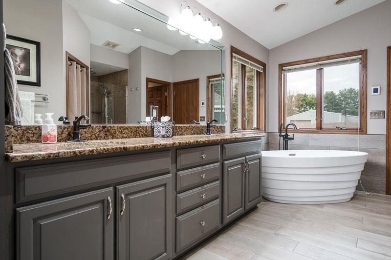 2412 Squaw Prairie Road Belvidere, IL 61008 - Photo 28 of 40 a bathroom with a granite countertop sink mirror and window