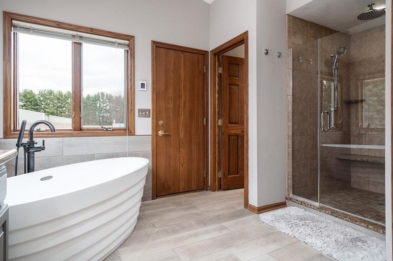2412 Squaw Prairie Road Belvidere, IL 61008 - Photo 29 of 40 a spacious bathroom with a tub and shower