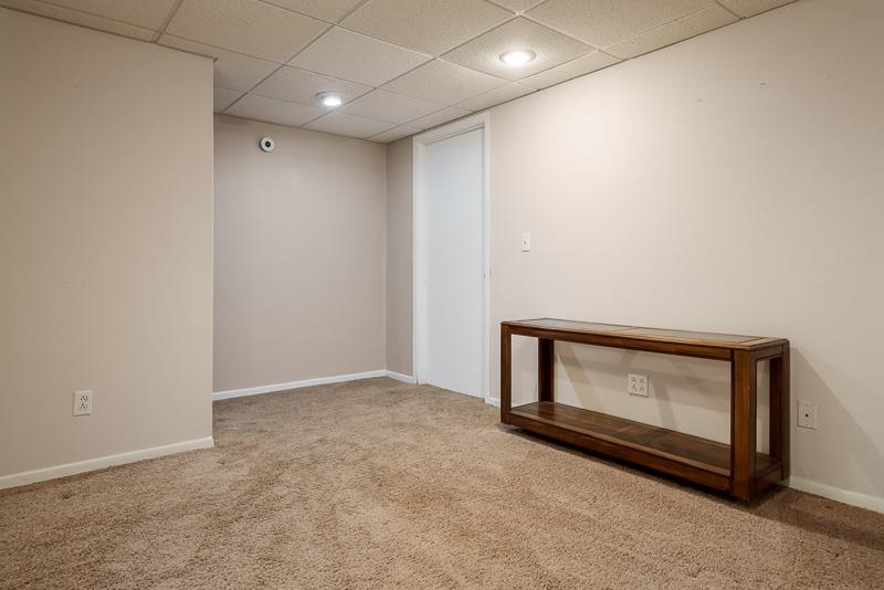 2412 Squaw Prairie Road Belvidere, IL 61008 - Photo 33 of 40 a view of an empty room with wooden floor and a window
