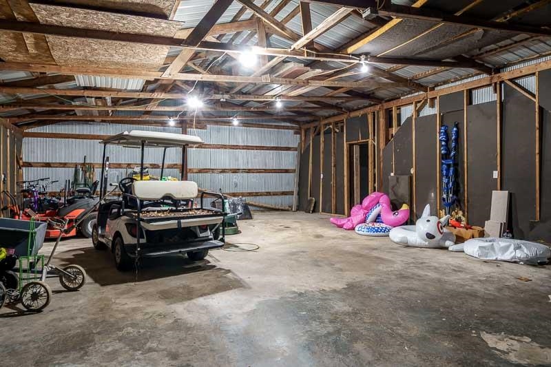 2412 Squaw Prairie Road Belvidere, IL 61008 - Photo 39 of 40 a view of a garage with a bike and wooden roof