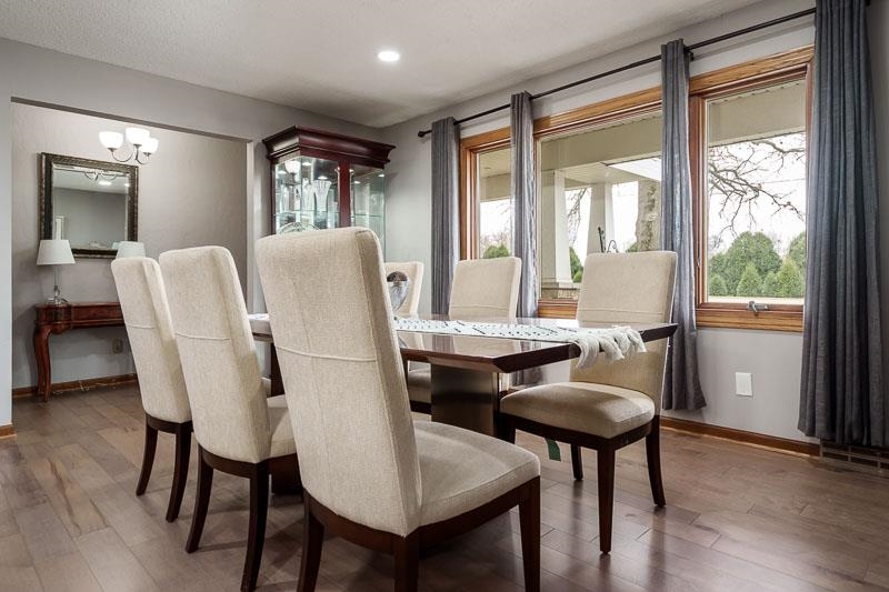 2412 Squaw Prairie Road Belvidere, IL 61008 - Photo 10 of 40 a dining room with furniture a chandelier and wooden floor