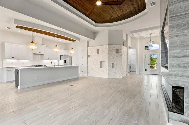 a kitchen with kitchen island granite countertop a stove and a sink