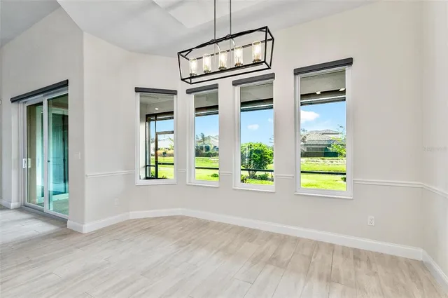 a view of an empty room with glass door and a window