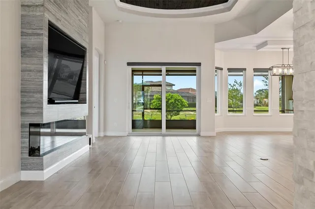 an empty room with a ceiling fan and a window