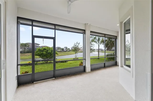 an empty room with windows and outdoor view