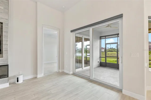 an empty room with a bathroom and mirror